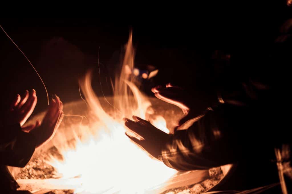 Warming hands by the campfire