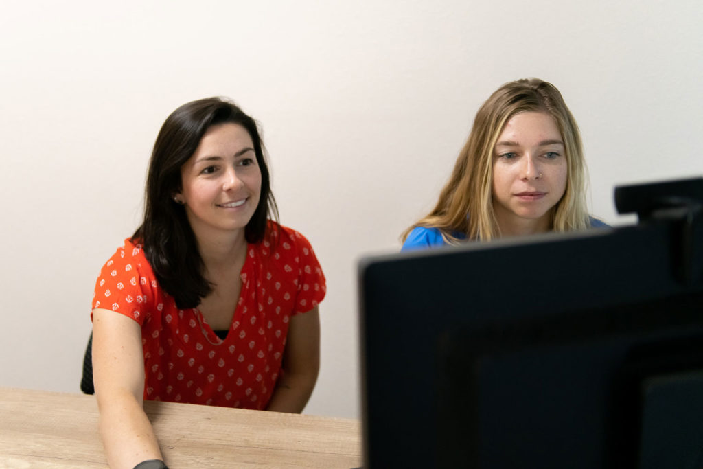 A therapist and a client engage in a virtual family therapy session, using telehealth technology to heal attachment issues and strengthen family bonds regardless of distance.