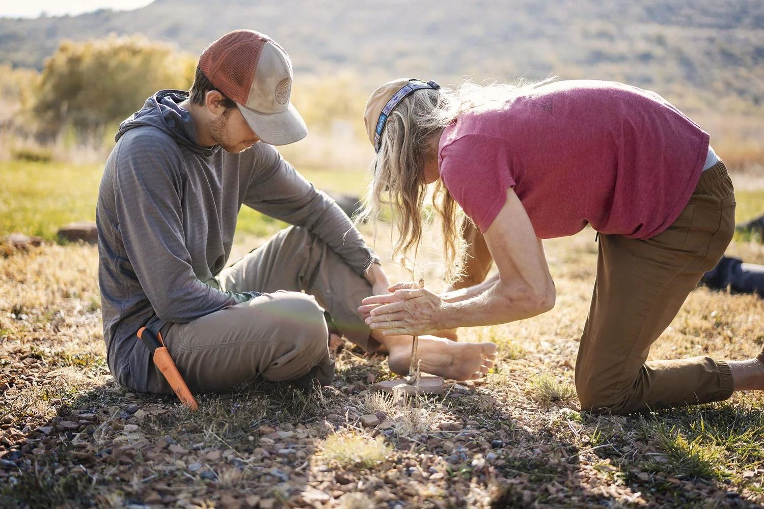 A mentor teaches a young man to create fire, a powerful experiential therapy exercise that symbolizes sparking hope, building focus, and developing the resilience needed for lasting addiction recovery.