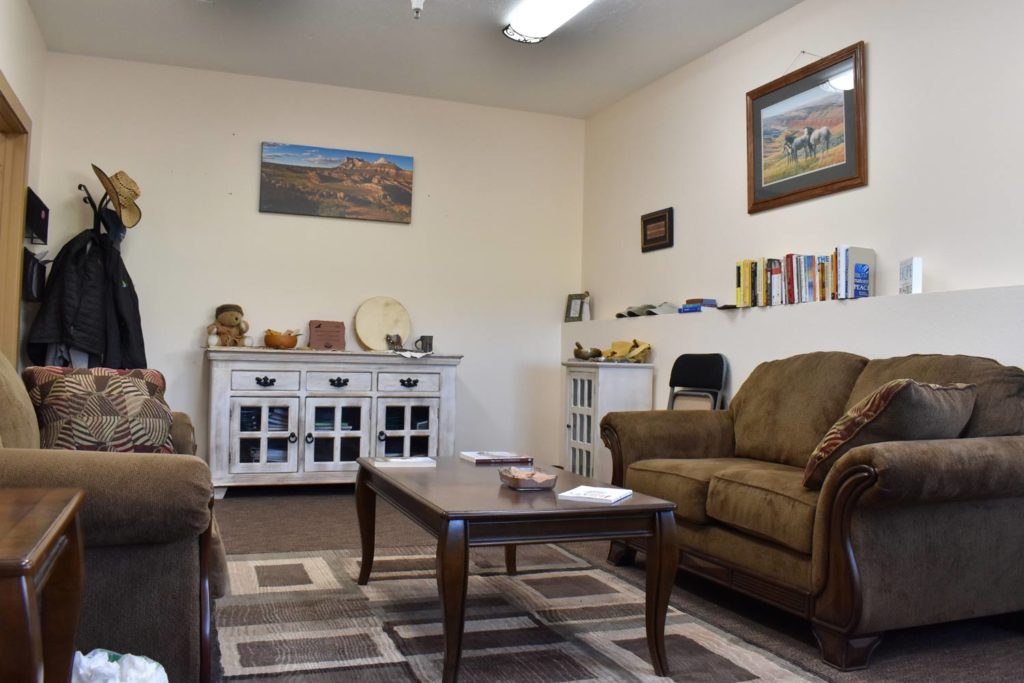The warm and inviting interior of a therapy office, featuring comfortable couches and calming decor, designed to create a safe and private environment for individual or group counseling.