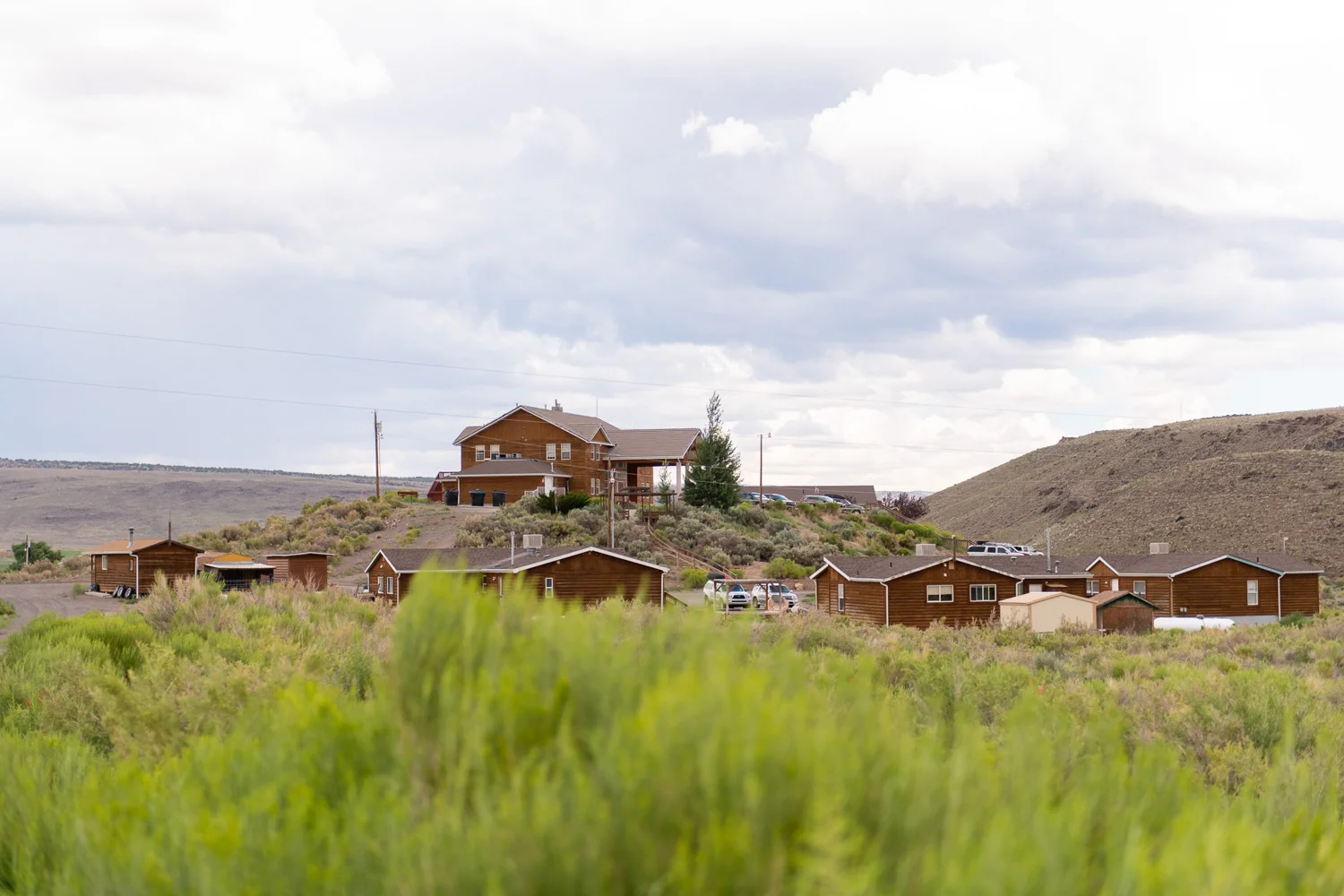 A view of the residential treatment facility, showing the main lodge and client cabins nestled in a quiet, rural landscape, providing a safe and structured environment for mental health and addiction recovery.