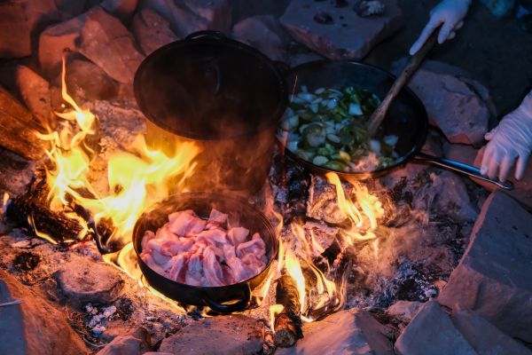 Campfire meal being prepared outdoors at Legacy Outdoor Adventures, where clients build life skills during residential addiction treatment.