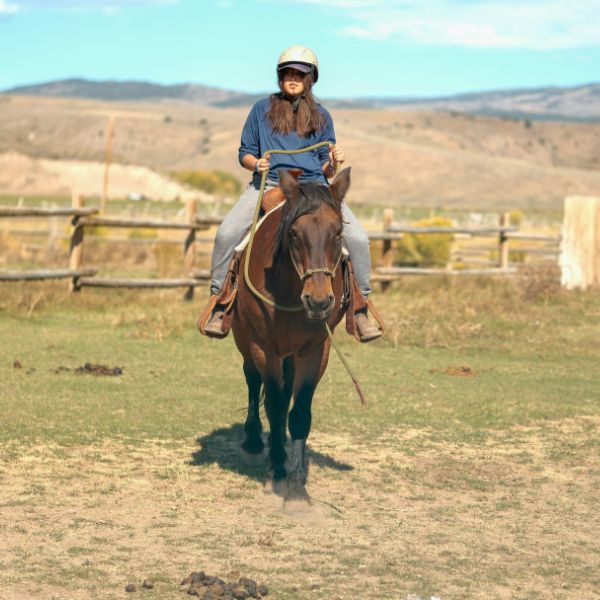 Client horseback riding on the Legacy Outdoor Adventures campus during an outdoor-based residential addiction treatment program in Texas.