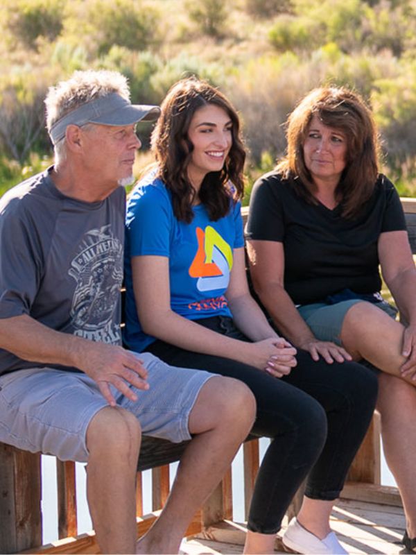 Clients participating in a group discussion at Legacy Outdoor Adventures' residential addiction treatment program, building support and connection in a peaceful outdoor setting.